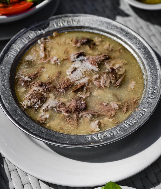 homemade beef broth soup with beef in bowl